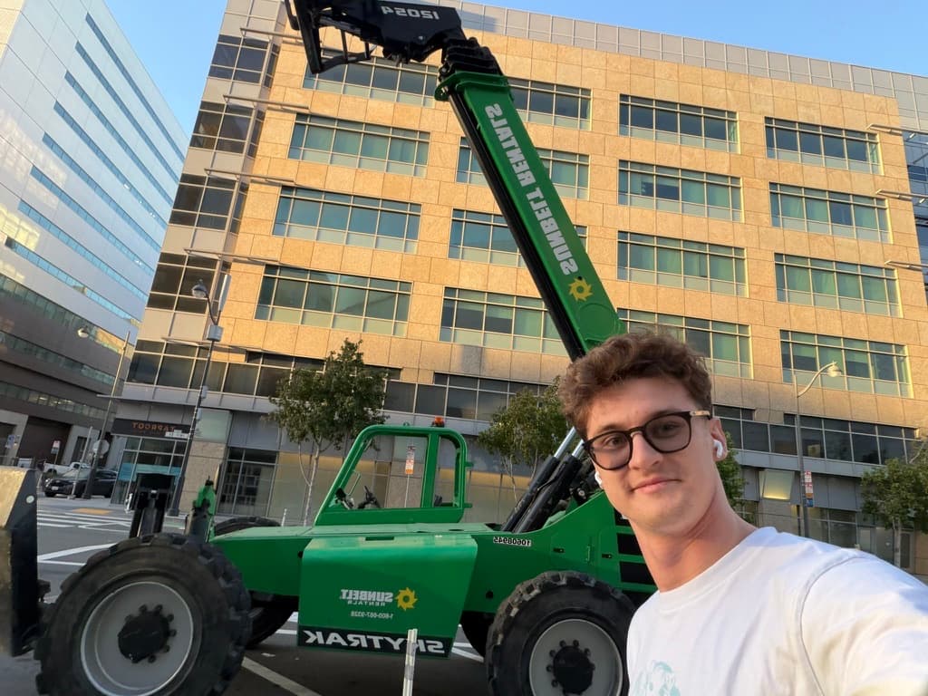 A Prox founder beside a telehandler during field work